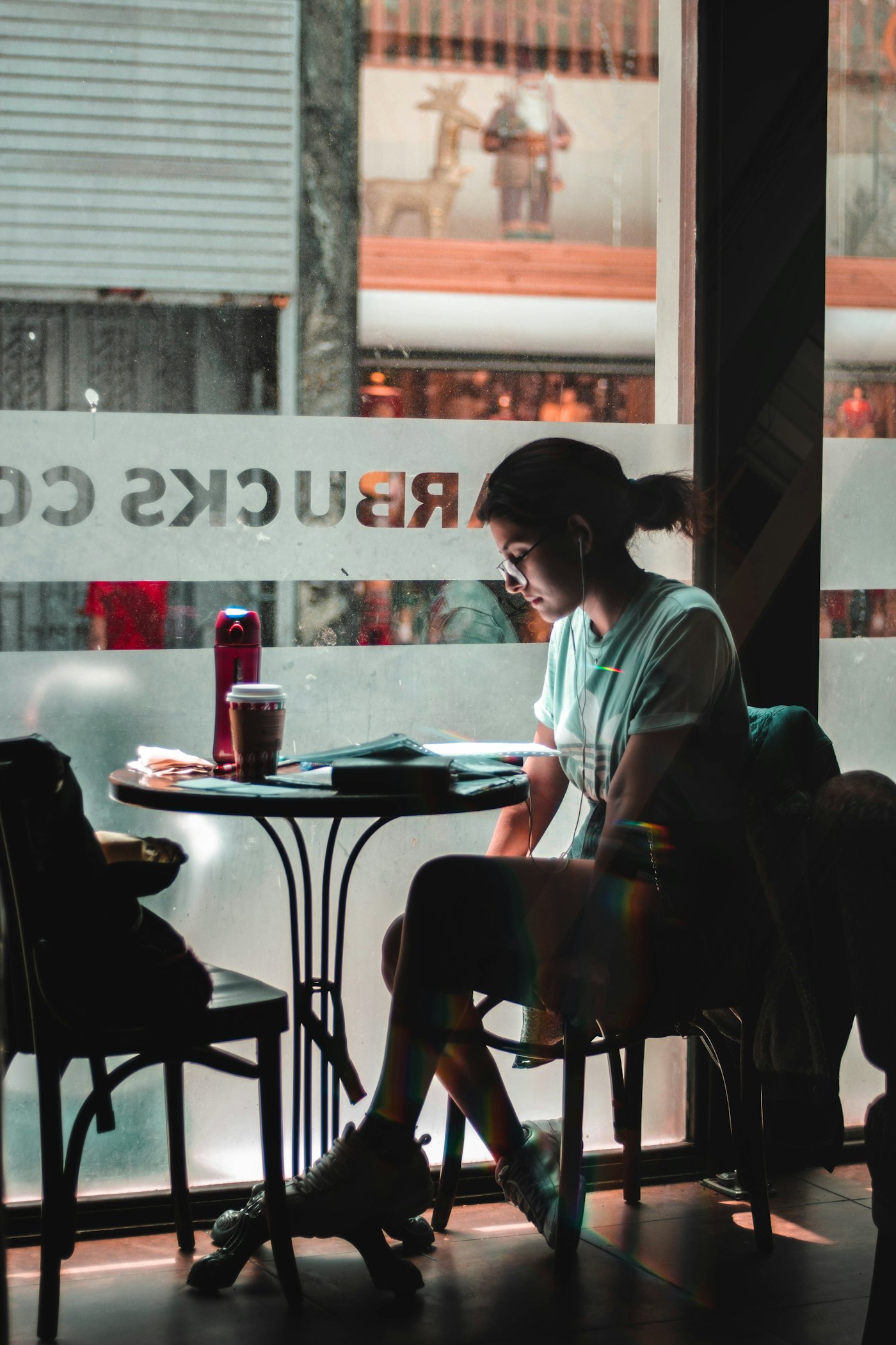 Person sitting alone by a window