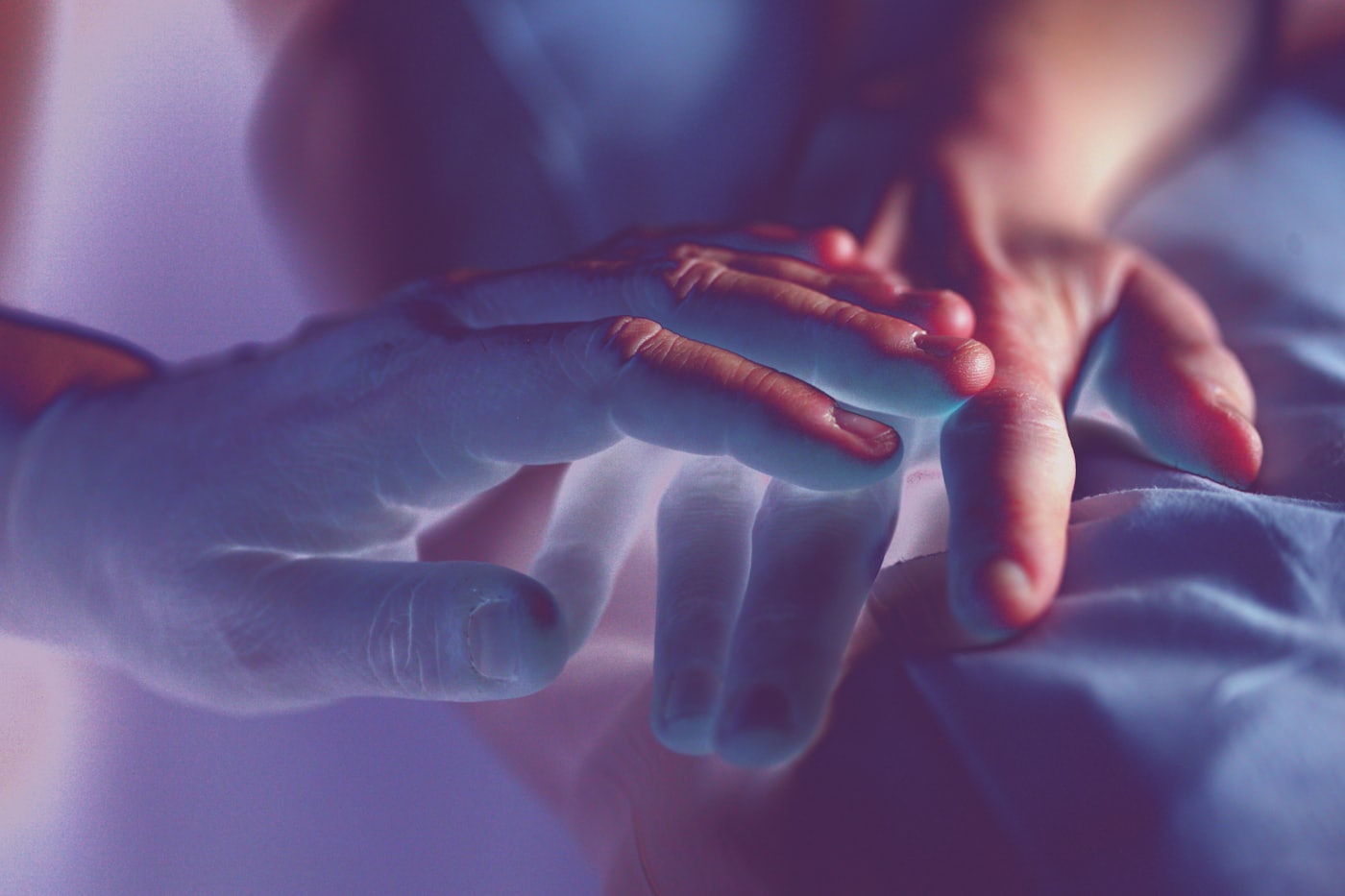 Two hands reaching toward each other