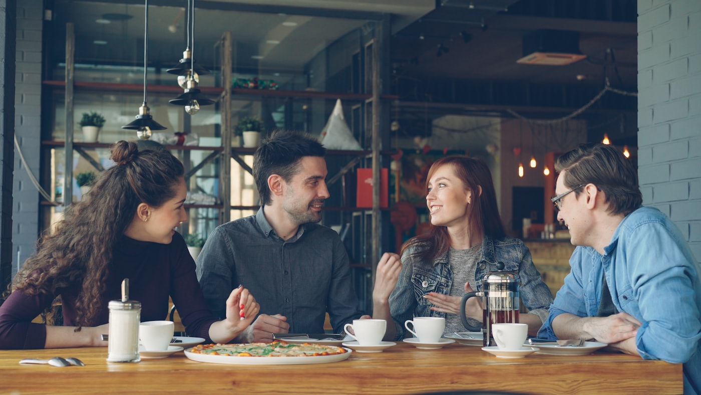 Friends in conversation over coffee